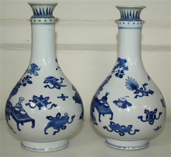 A pair of Chinese blue and white bottle vases, Kangxi period, 19.5cm, rims restored